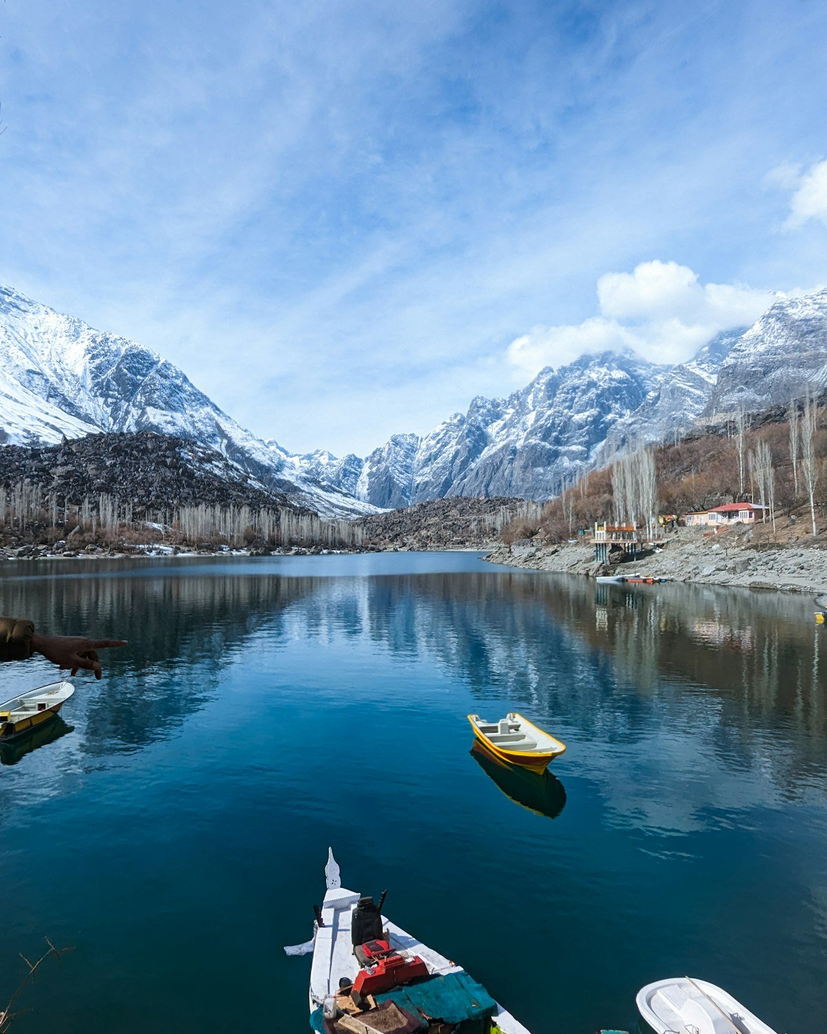 Boats on the calm blue-green water of Lower Kachura Lake near Skardu